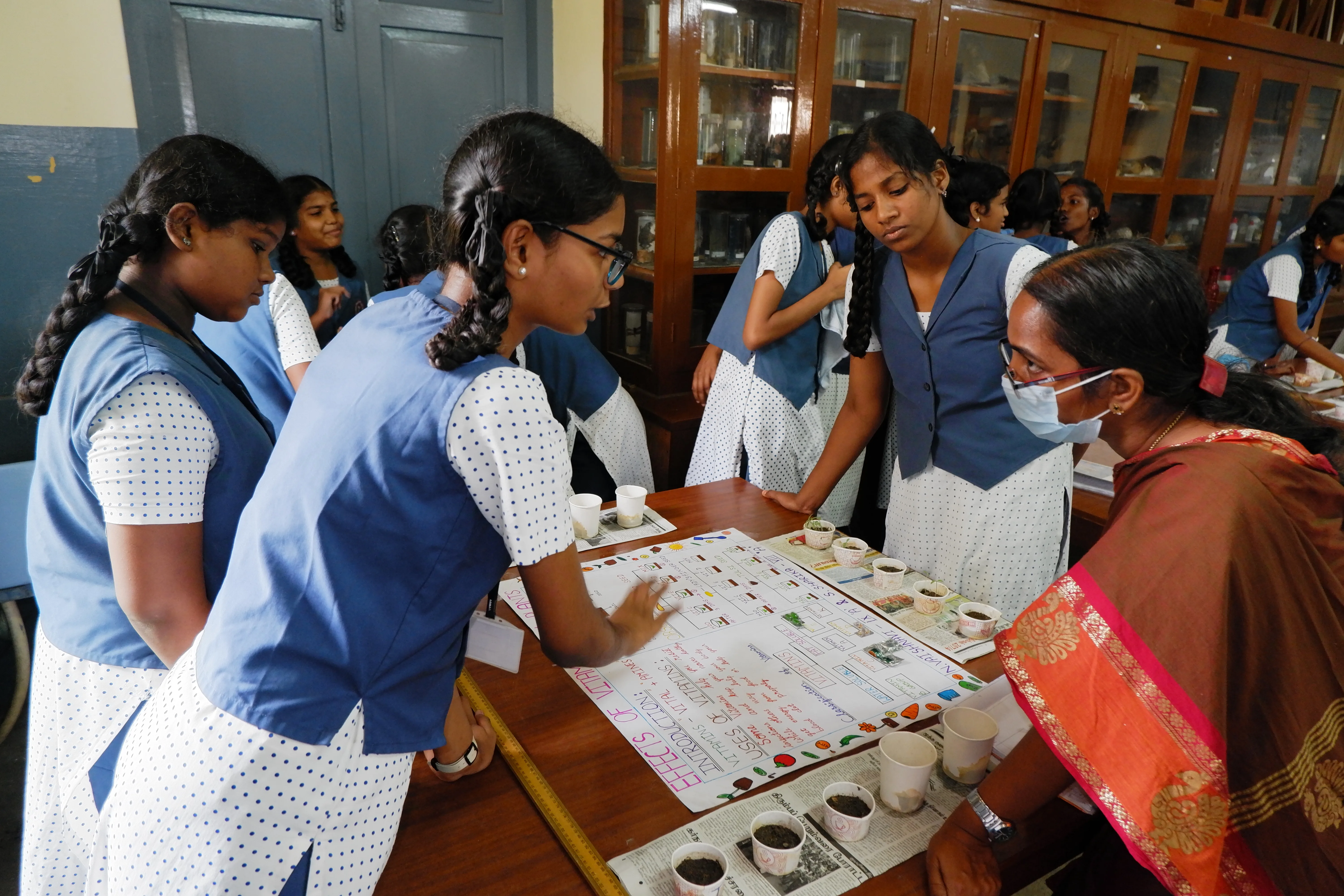 Students and their teacher exploring a hands-on science activity at a KSICT partner school